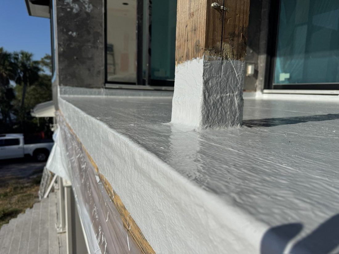 Coated deck edge and coping detail carried up to the sliding glass door threshold