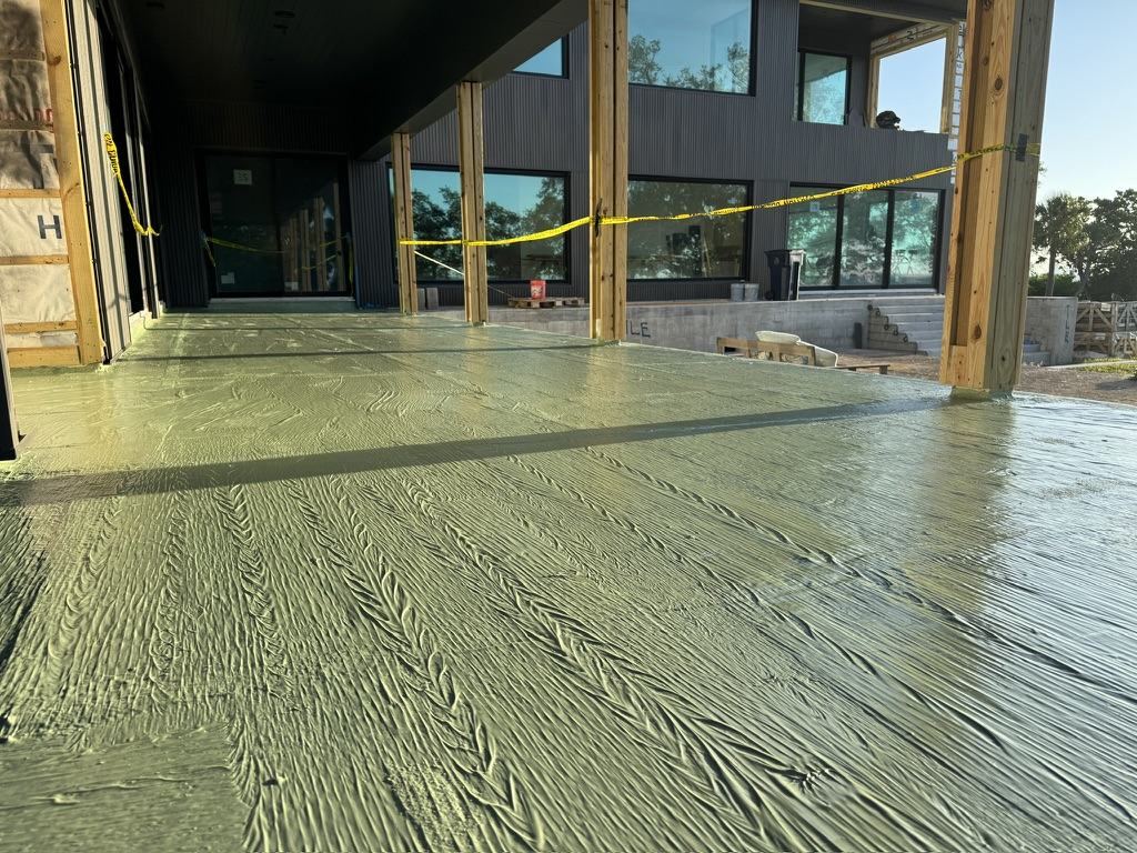 Fluid-applied deck coating on a covered lanai, turned up at column bases and door thresholds