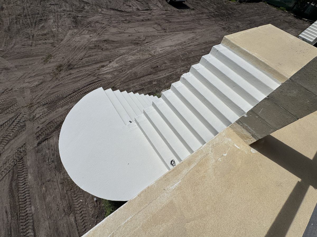 Waterproof coating applied to exterior concrete stair treads and curved landing