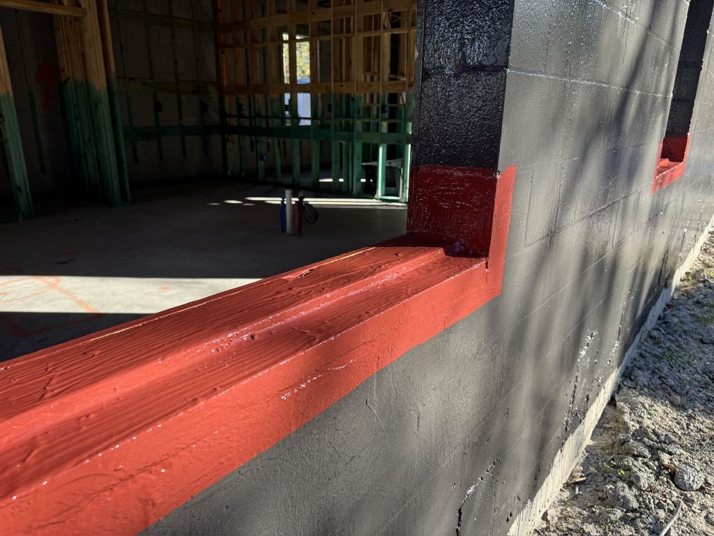 Liquid flashing detail at the wall base and slab transition