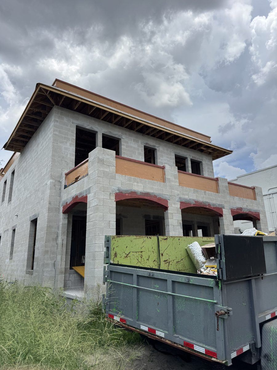 Barrier coating and liquid flashing detailing around openings on a CMU building